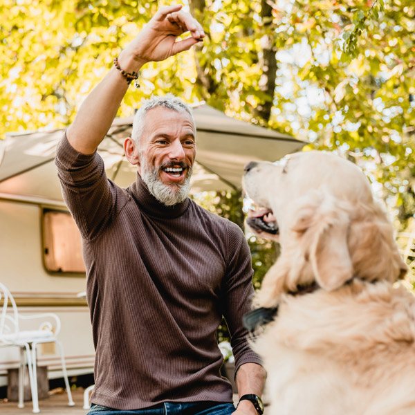 man giving his dog a treat